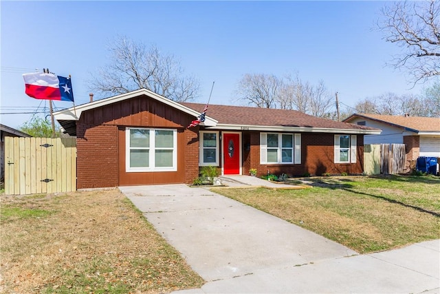 single story home with a gate, brick siding, a front yard, and fence