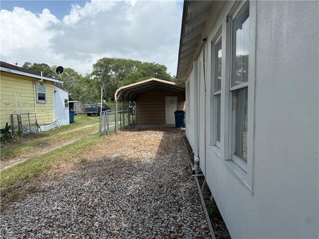 109 S Verne St, Rockport, TX 78382 - view of yard featuring driveway and a carport