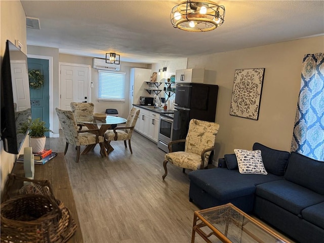 109 S Verne St, Rockport, TX 78382 - living area with a chandelier, light wood-style floors, and an AC wall unit