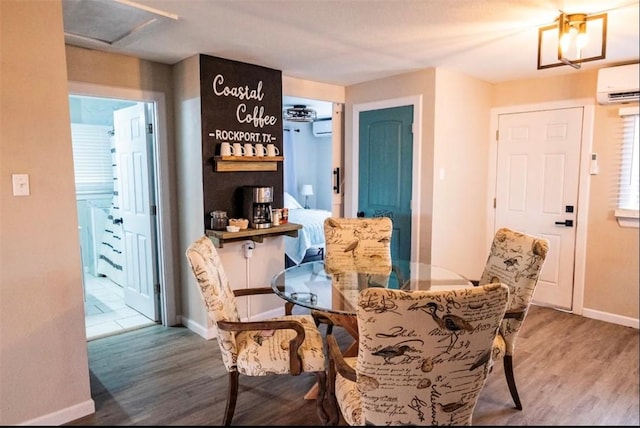 109 S Verne St, Rockport, TX 78382 - dining space featuring a wall mounted AC and wood finished floors