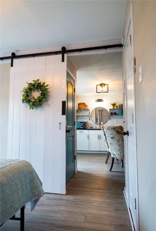 109 S Verne St, Rockport, TX 78382 - corridor featuring a barn door and wood finished floors