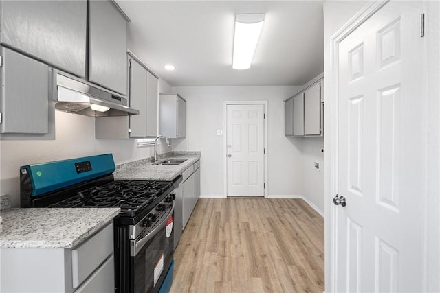 kitchen with stainless steel appliances, light hardwood / wood-style floors, sink, and gray cabinetry