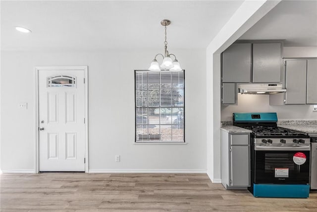 kitchen with decorative light fixtures, gray cabinetry, a notable chandelier, stainless steel gas range oven, and light hardwood / wood-style flooring