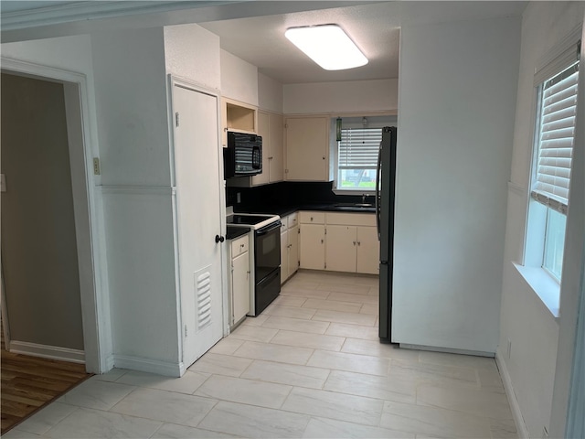 kitchen featuring sink and black appliances