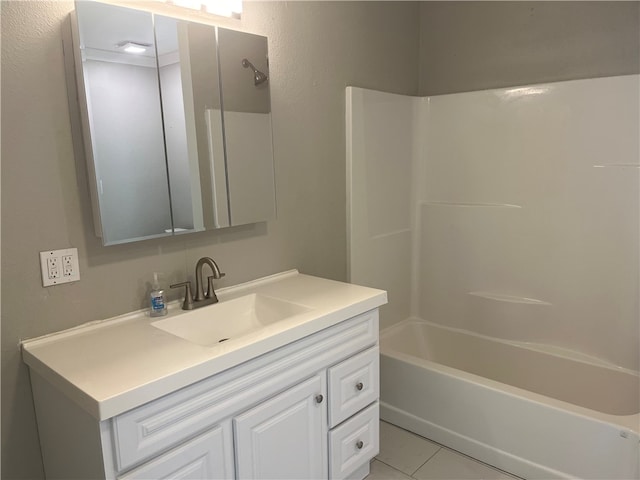 bathroom with washtub / shower combination, tile patterned floors, and vanity