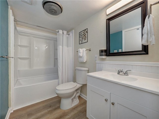 full bath with vanity, wood finished floors, toilet, and shower / bathtub combination with curtain