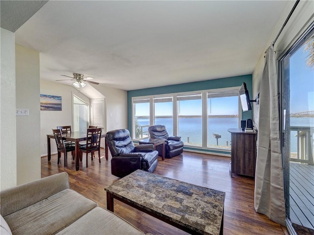 living area featuring ceiling fan and dark wood finished floors