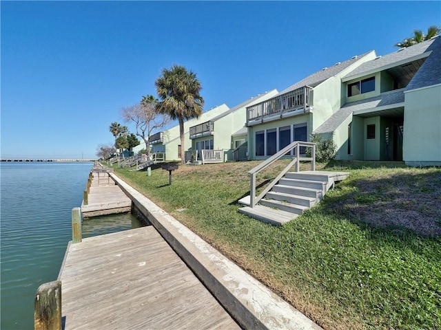 dock area featuring a yard and a water view