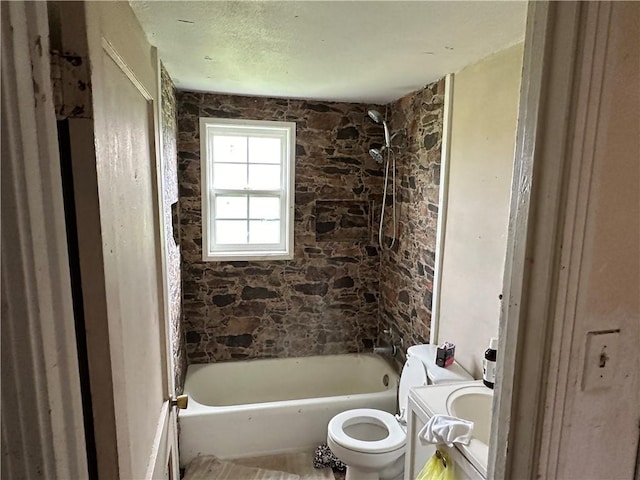 full bathroom featuring sink, shower / bath combination, and toilet