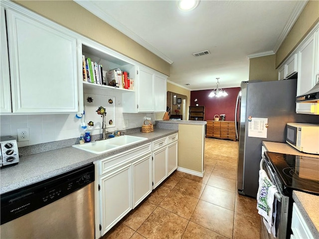 2742 Bramblebush Dr, Corpus Christi, TX 78410 - kitchen featuring stainless steel appliances, ornamental molding, white cabinetry, backsplash, and light countertops