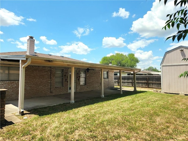 2742 Bramblebush Dr, Corpus Christi, TX 78410 - rear view of house featuring a patio, brick siding, a chimney, and a storage shed