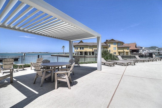 view of patio / terrace with a pergola and a water view