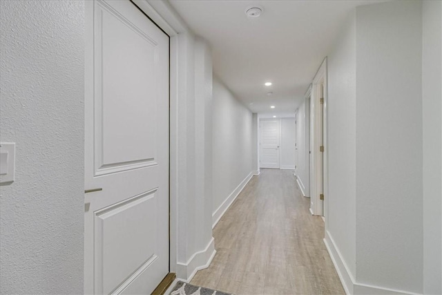 corridor with light hardwood / wood-style flooring