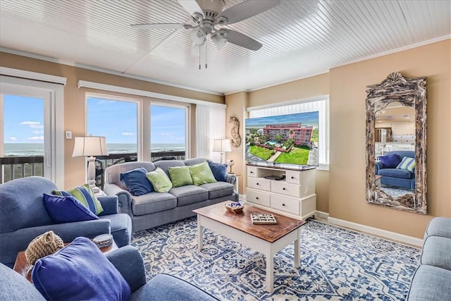 living room featuring ceiling fan and a water view