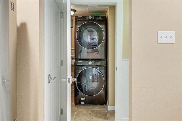 washroom featuring stacked washer and dryer