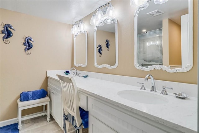 bathroom featuring vanity, tile patterned floors, and a shower