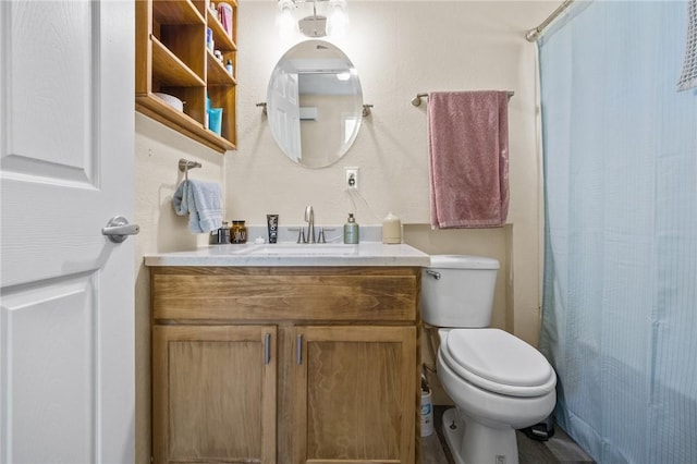 bathroom with toilet, vanity, and curtained shower