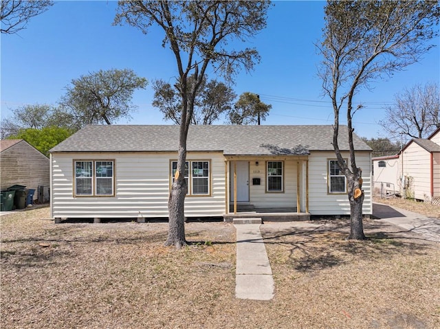 ranch-style home with roof with shingles