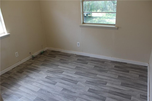 spare room with wood-type flooring