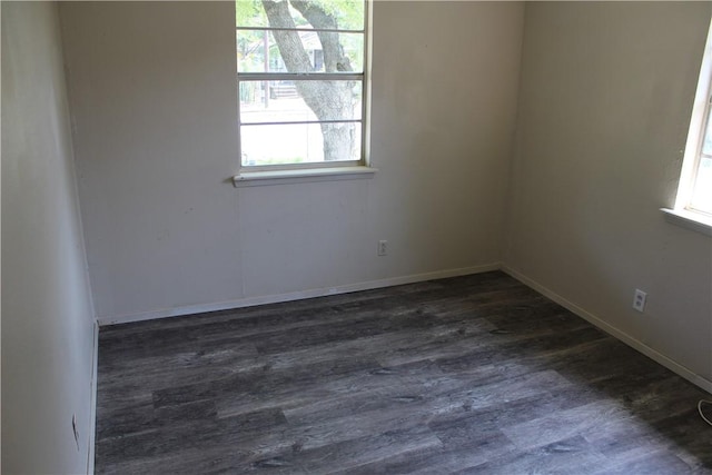 spare room with dark hardwood / wood-style flooring