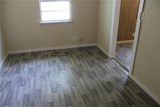 empty room featuring dark hardwood / wood-style flooring