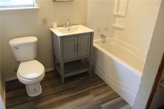 bathroom with hardwood / wood-style floors, vanity, and toilet