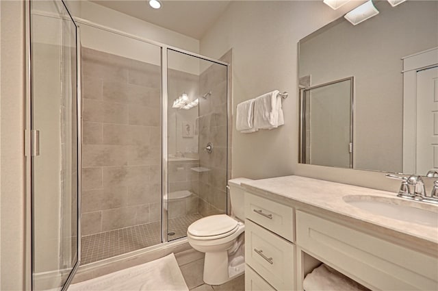 bathroom featuring an enclosed shower, vanity, tile patterned floors, and toilet