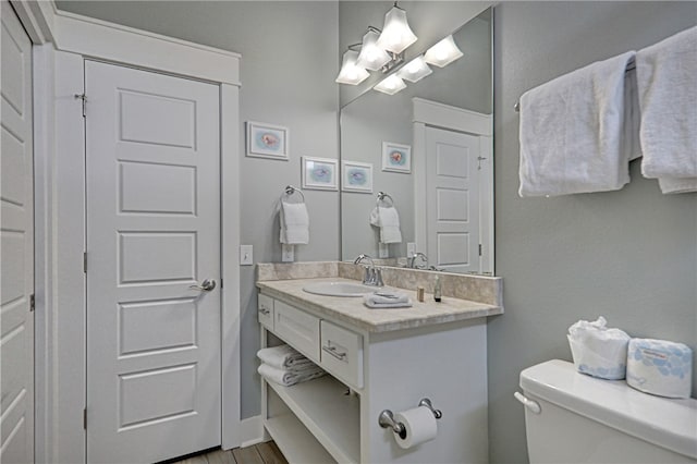 bathroom featuring hardwood / wood-style floors, vanity, and toilet