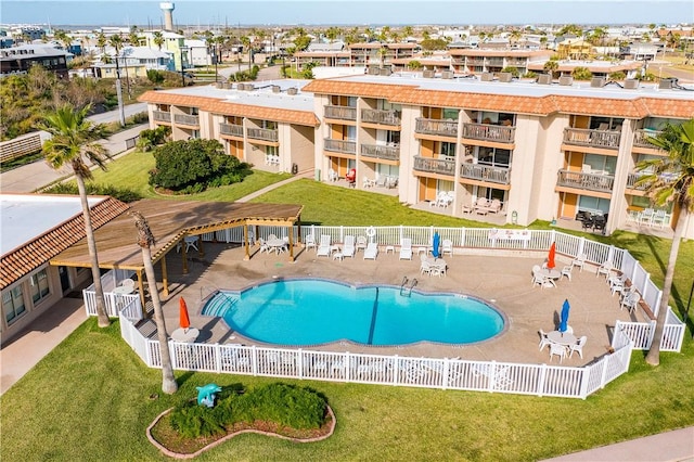 view of swimming pool featuring a patio and a lawn