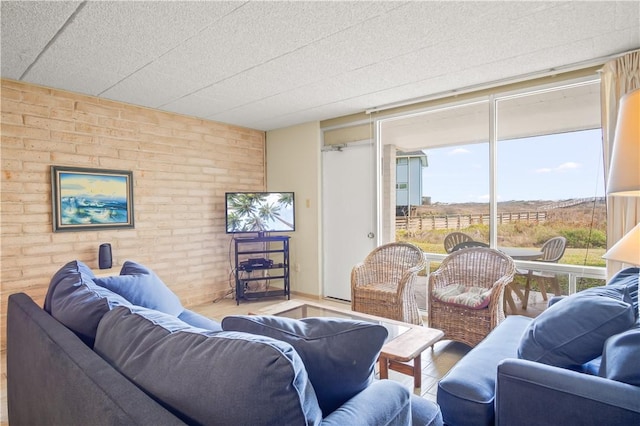 living room with brick wall and plenty of natural light