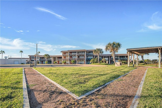 view of community featuring a pergola and a lawn