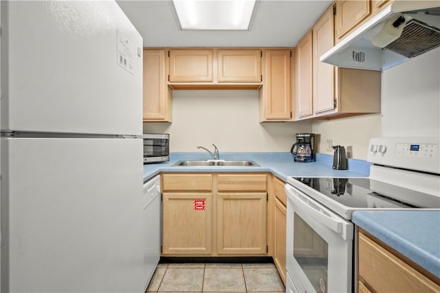 kitchen with sink, white appliances, light tile patterned floors, and light brown cabinets