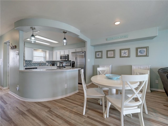 dining area featuring light hardwood / wood-style flooring and sink