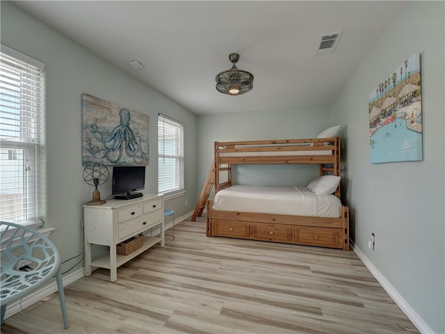 bedroom featuring light hardwood / wood-style floors and multiple windows