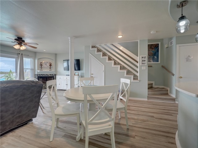 dining room featuring a textured ceiling, light hardwood / wood-style floors, and ceiling fan