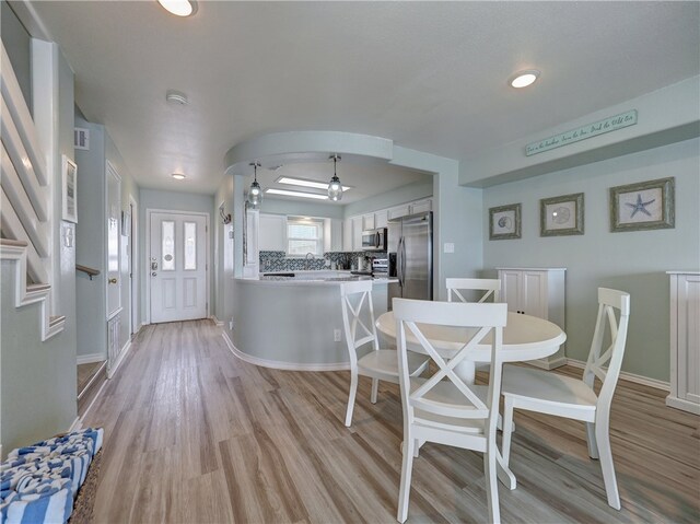 dining room with light wood-type flooring