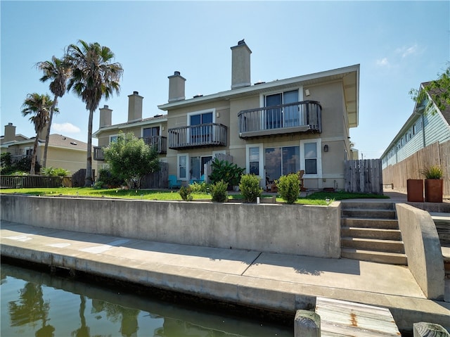 back of property featuring a balcony