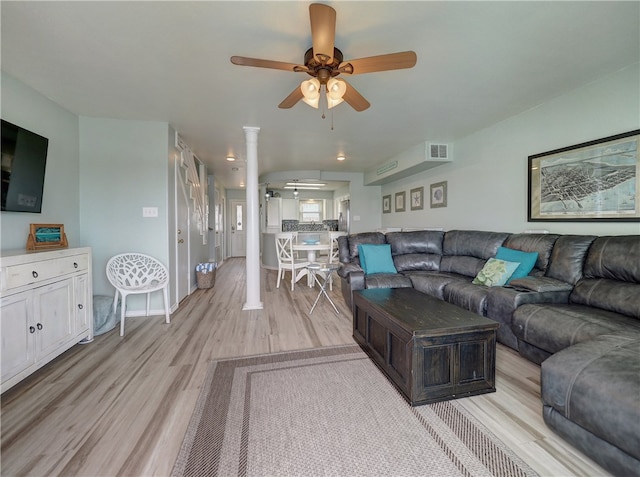 living room featuring ceiling fan, ornate columns, and light hardwood / wood-style floors