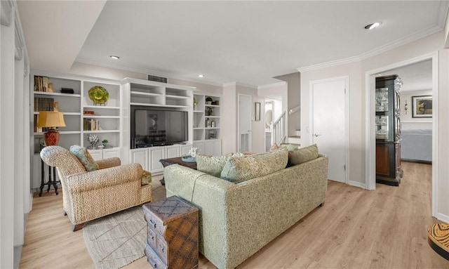 living room with crown molding and light hardwood / wood-style flooring