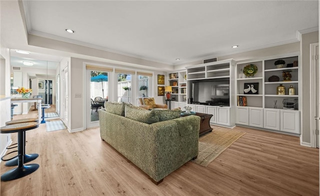 living room featuring crown molding and light wood-type flooring