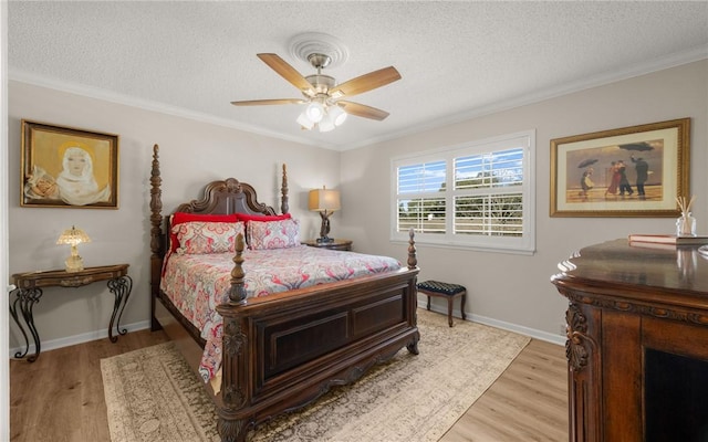 bedroom with ornamental molding, a textured ceiling, ceiling fan, and light hardwood / wood-style flooring