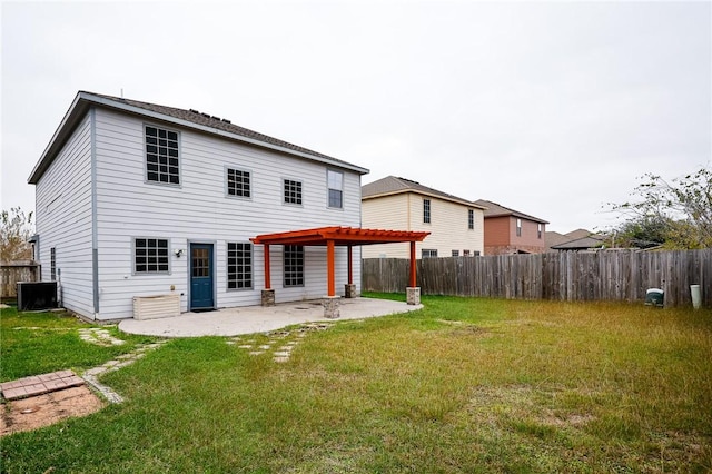 back of property featuring cooling unit, a yard, and a patio area