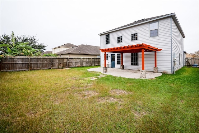 rear view of house featuring a yard, a pergola, and a patio