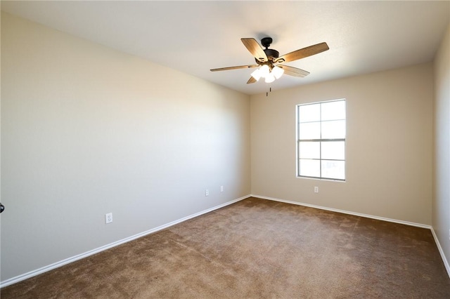 spare room featuring dark carpet and ceiling fan