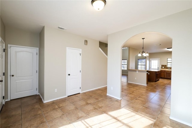 empty room with an inviting chandelier