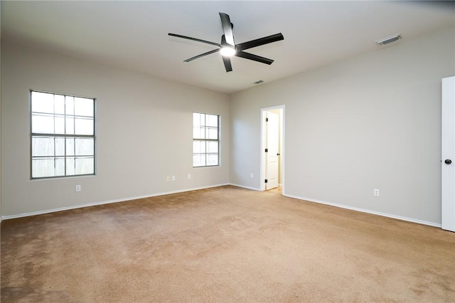 carpeted spare room featuring ceiling fan