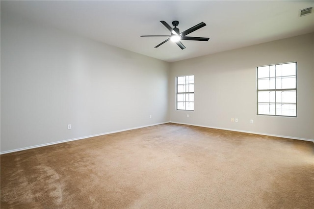 empty room featuring ceiling fan and carpet flooring