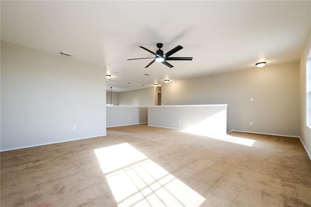 empty room with light colored carpet and ceiling fan