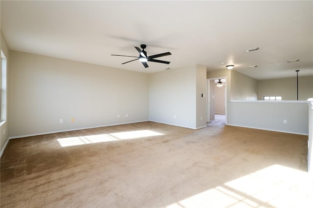 carpeted spare room with ceiling fan