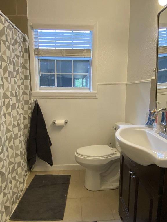 full bath with toilet, vanity, tile patterned floors, and a shower with shower curtain
